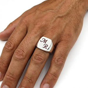 Chevalière en argent massif de forme ovale et personnalisée de 2 lettres émaillées de couleur rouge foncé.